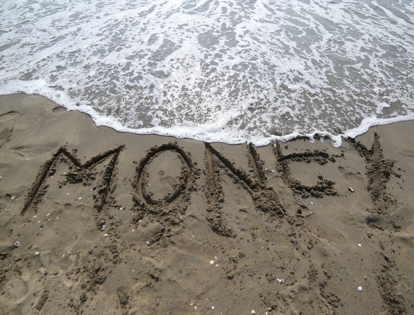 081060861-word-money-written-sand-and-wa.jpeg