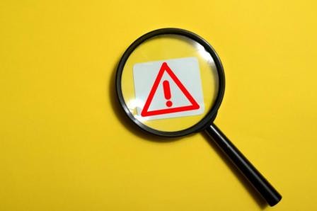 241513661-magnifier-glass-red-triangle-compressed.jpeg
